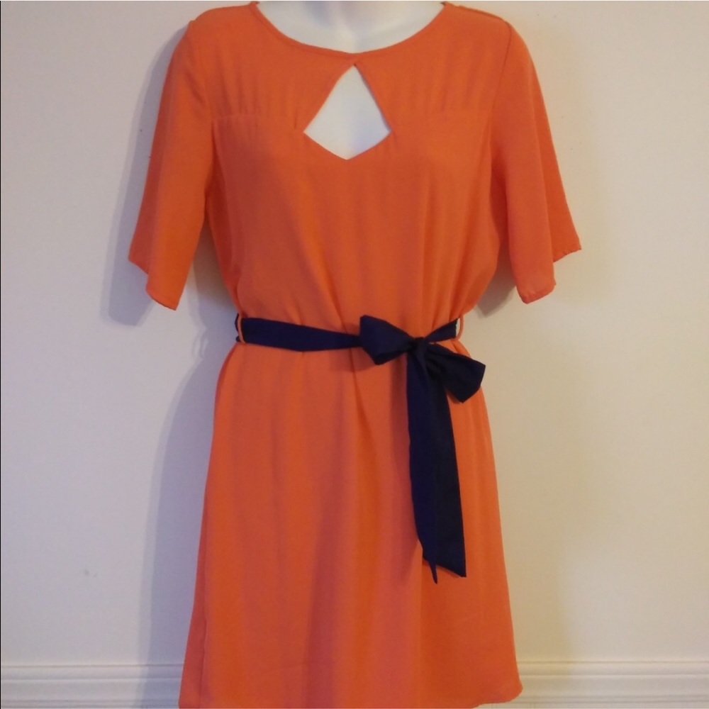 Keyhole neckline. Knee length blue belt
